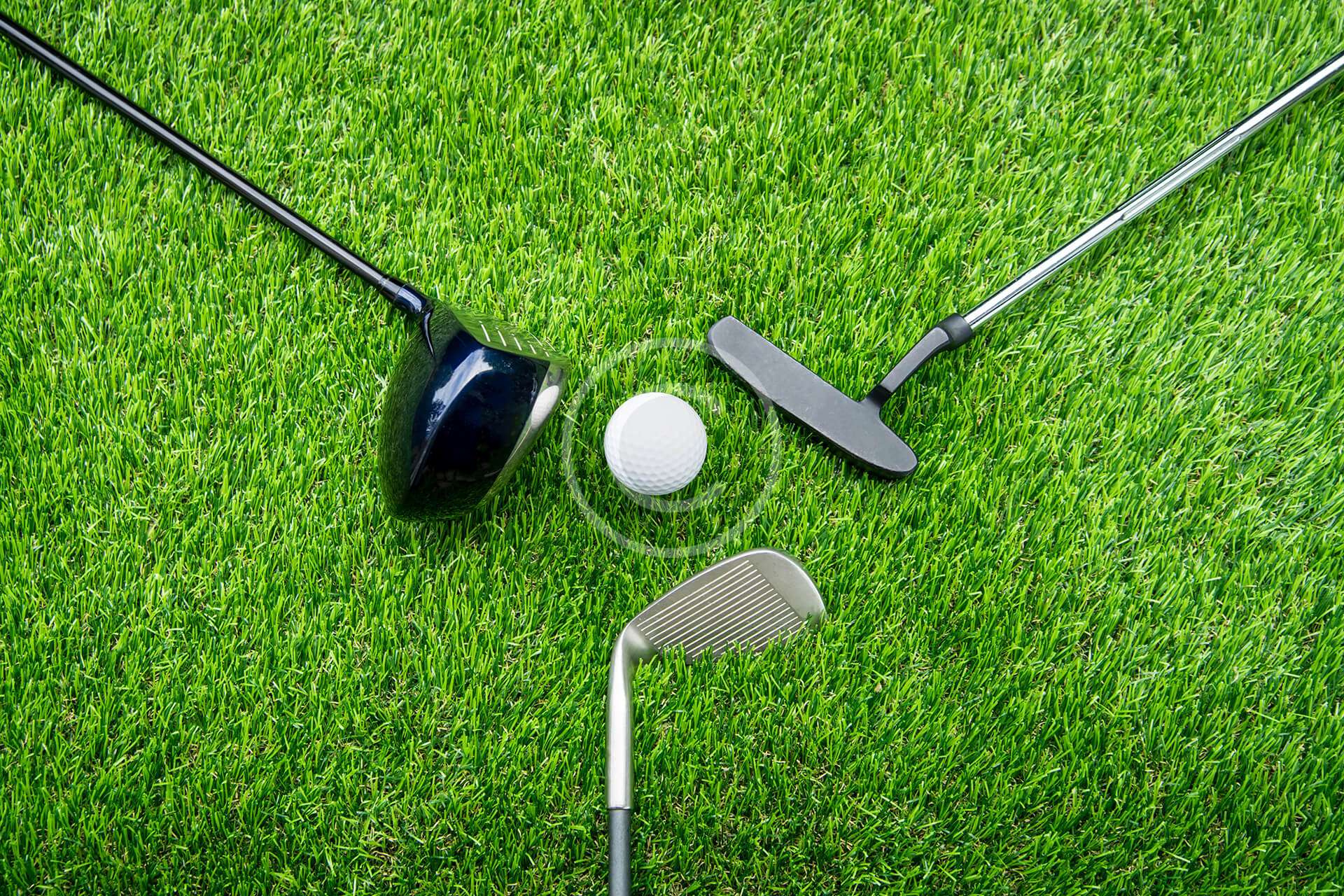 Three golf clubs arranged with a golf ball in the center, ready for action.