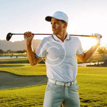 A man holding a golf stick, preparing to hit the ball, with a copyright logo.