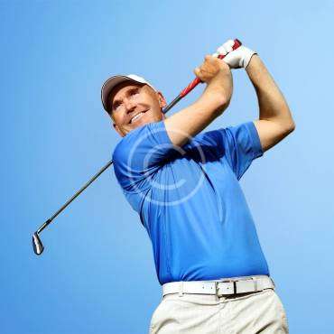 A man in a follow-through position with a golfing stick after hitting the ball, with a copyright logo.