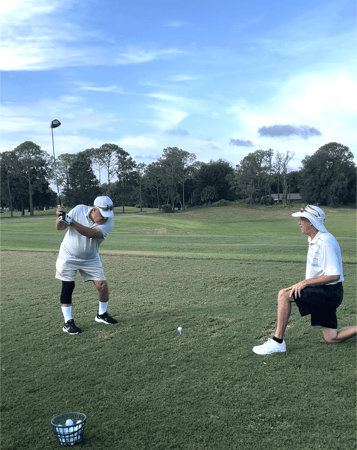 Golfer practicing at the daily driving range to improve their driving skills.